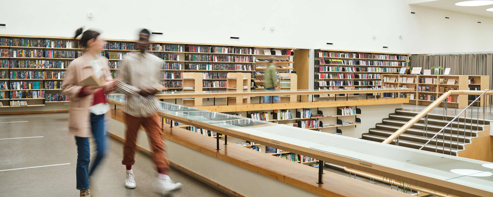 Canadian libraries themed stock - blurred motion of people walking along the corridor in big library